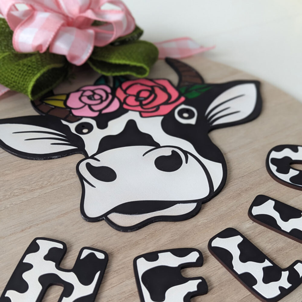 door hanger with cow had and word hello