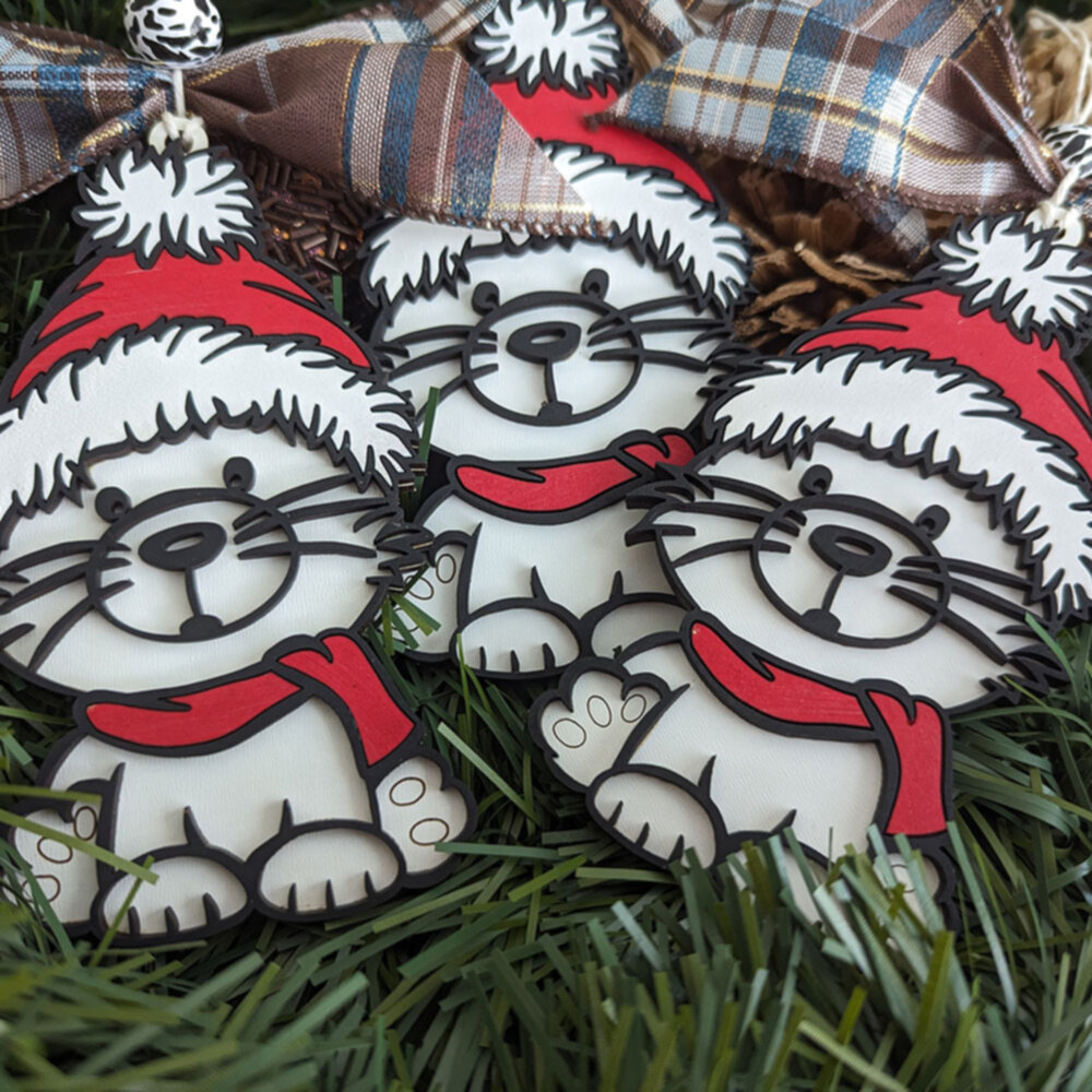 Three cats with red hat christmas ornaments.