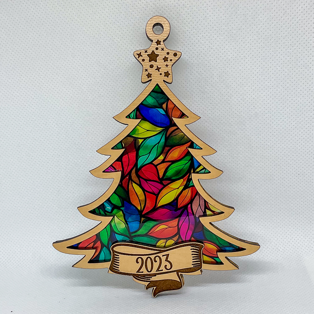 A Christmas tree ornament with a colorful stained glass inlay.