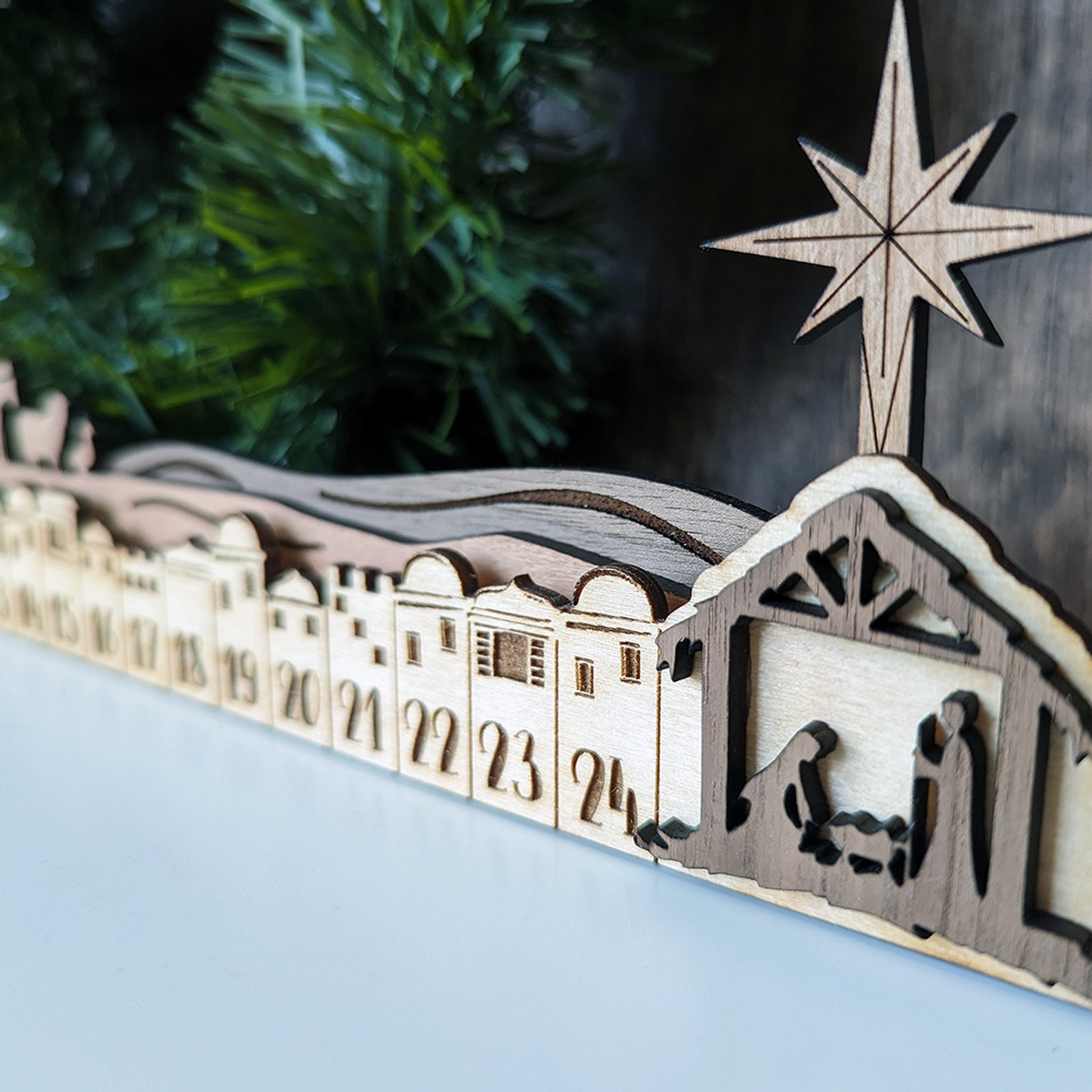 A closeup of our Nativity Calendar: The manger, with the star shining over it.