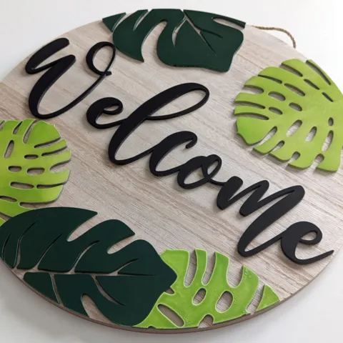 welcome sign with tropical leaves