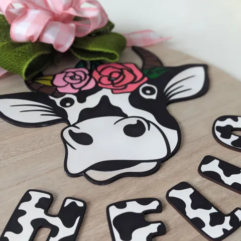 door hanger with cow had and word hello