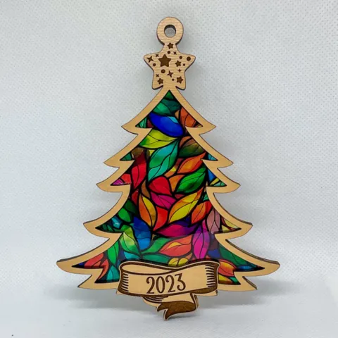 A Christmas tree ornament with a colorful stained glass inlay.