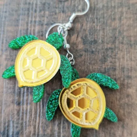 Glittering green and metallic gold sea turle earring