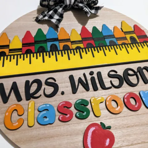 A brightly colored round sign for a teacher's classroom