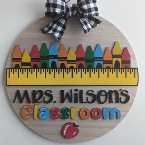 A brightly colored round sign for a teacher's classroom