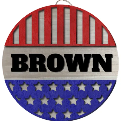 A round sign with the first 1/3 being red with cut out vertical stripes, then the name BROWN in large chunky lettering, then the final third being blue with cut out stars.