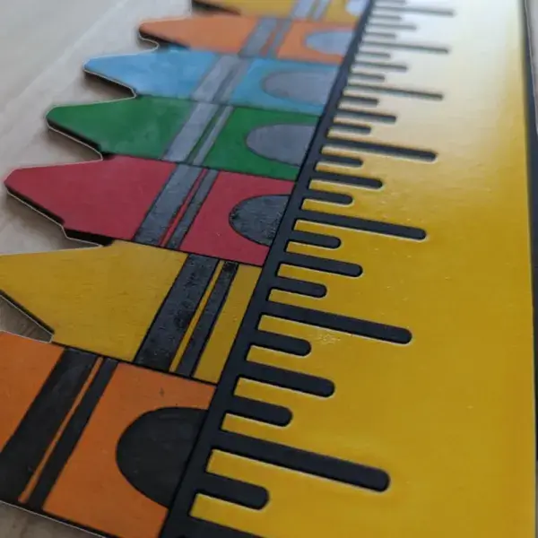 A brightly colored round sign for a teacher's classroom