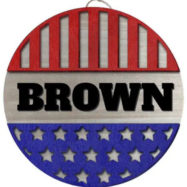 A round sign with the first 1/3 being red with cut out vertical stripes, then the name BROWN in large chunky lettering, then the final third being blue with cut out stars.